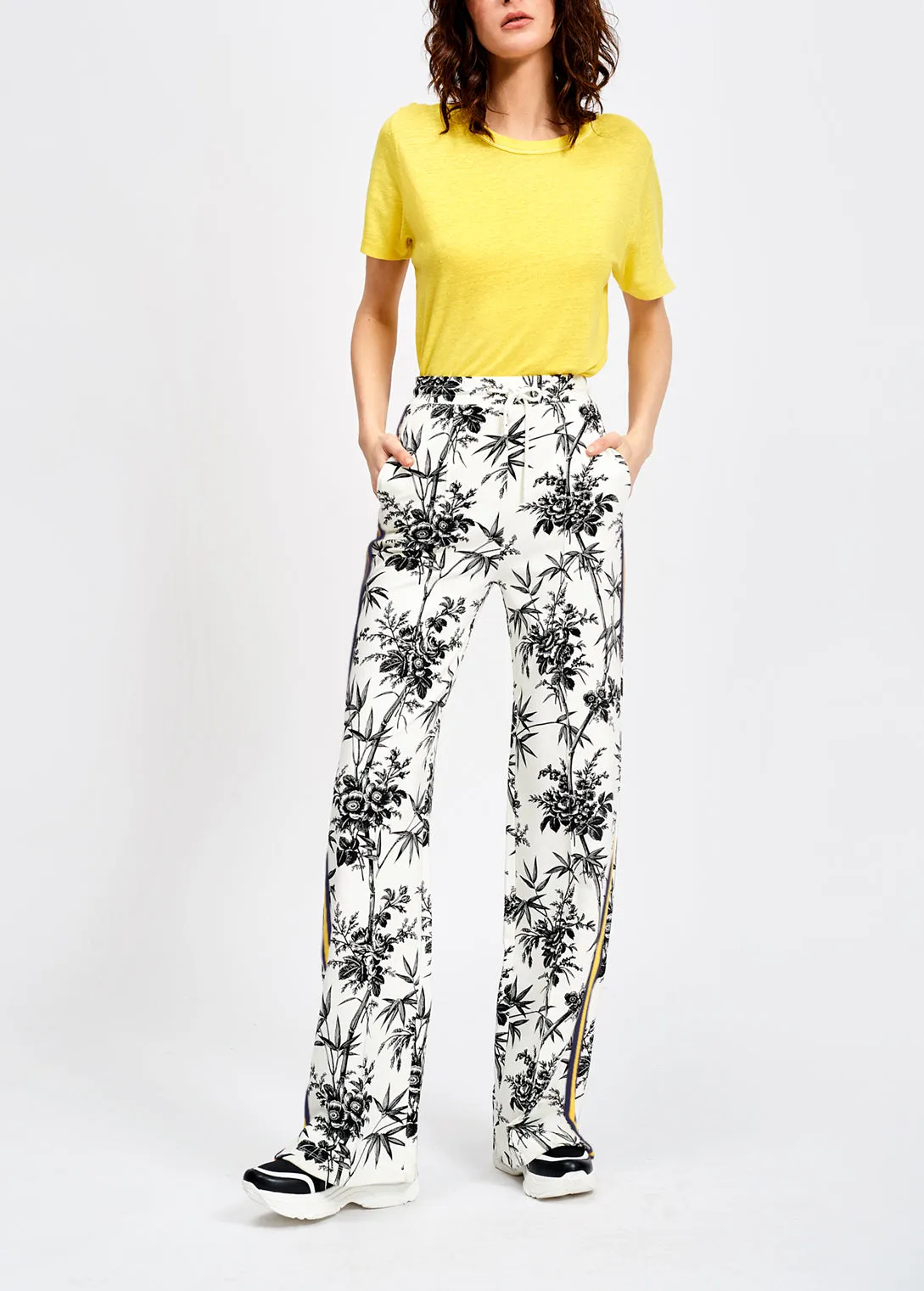 Classic white tracksuit pants with black print